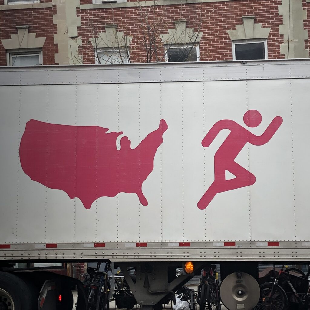 Current image: ID: stick figure appears to be running away from the shape of the united states